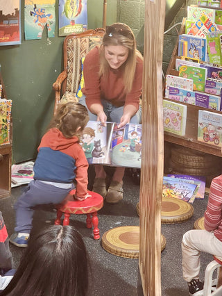 Katie Weaver reading one of her books to children in Tattered Cover Bookstore.