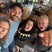 Four people taking a selfie from above in a restaurant setting