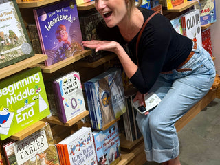 Author Katie Weaver leaning over an and pointing at her book, Have You Ever Wondered?, in Barnes & Noble.