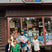 Katie Weaver and her children standing in front of a store named 'MacDonald Book Shop'.